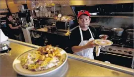  ?? Gary Coronado Los Angeles Times ?? FOOD SERVICE jobs were among those to see increases in Los Angeles County in July. Above, Jesus Matias prepares dishes at the Nickel Diner in downtown L.A.