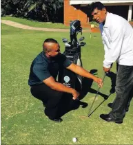  ??  ?? Nisharlan helps Sonny Pillay get to grips with the putter.