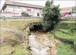  ?? (Courtesy pic) ?? A section of the Mbabane River where it passes through the Sales House Building and the Mbabane Market premises. Another section of the river.