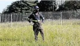  ?? Picture: SUPPLIED ?? VOLUNTEER: Mandilakhe Matuwana working for free tidying and cutting the grass at the Beacon Bay and Nompumelel­o clinics