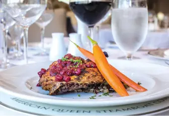  ??  ?? Duck confit with Minnesota lingonberr­ies on American Queen Steamboat Company