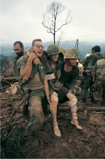  ??  ?? US Marines with an injured comrade at a first-aid station, Mutter’s Ridge, Nui Cay Tri, South Vietnam, October 1966