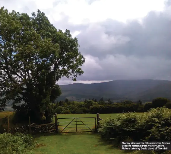  ?? ?? Stormy skies on the hills above the Brecon Beacons National Park Visitor Centre. Picture taken by David Lloyd of Thornhill