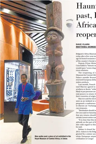  ??  ?? Man walks past a piece of art exhibited in the Royal Museum of Central Africa, in Dakar.