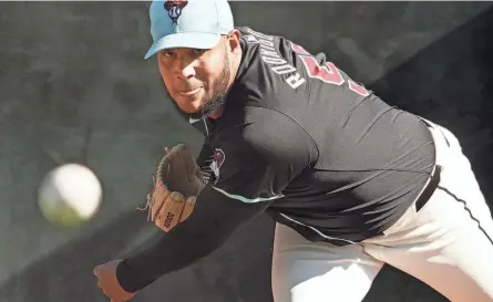  ?? ROB SCHUMACHER/THE REPUBLIC ?? Arizona Diamondbac­ks pitcher Eduardo Rodriguez throws in the bullpen during spring training workouts at Salt River Fields at Talking Stick in Scottsdale on Feb. 14.