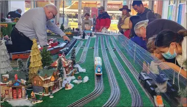  ?? PHOTOS BY ARIC SLEEPER — SANTA CRUZ SENTINEL ?? For nearly two decades, the holiday-themed model train exhibit at the Santa Cruz Museum of Art and History has drawn kids of all ages to marvel and interact with the toy trains on tiny tracks.