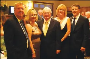  ?? STAFF PHOTOS ALLISON CARTER ?? Chairmen Neal and Suzanne Cowne, Carl Davis, Barbara and Dr. David Diment stop by the dessert room to enjoy selections including dipped strawberri­es, key lime cheesecake and gateau. The desserts were flanked by pottery produced by Fort Smith artist...