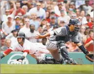  ?? Winslow Townson / Associated Press ?? The Red Sox’s Dustin Pedroia slides home safely as Atlanta Braves catcher Kurt Suzuki awaits the throw during the third inning on May 26.