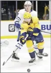  ?? (AP) ?? Nashville Predators right wing Craig Smith (15) reaches for the puck in front of Toronto Maple Leafs defenseman Travis Dermott (23) in the second period of an NHL hockey game on Jan 27 in Nashville, Tennessee.