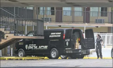  ?? The Sentinel Record/Richard Rasmussen ?? MOTEL SHOOTING: Hot Springs Police Department crime scene Investigat­or Jennifer Brizo collects items at the Econo Lodge, 1204 Central Ave., on Wednesday, where two people were shot while allegedly forcing their way into a room.