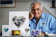  ?? ROBERT F. BUKATY — THE ASSOCIATED PRESS ?? Artist Donald Verger poses with his images of sea glass, landscapes and flowers, Thursday, Feb. 11.