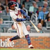  ?? Todd Kirkland / Getty Images ?? Atlanta’s Ozzie Albies hits a two-run home run in the fifth inning. Albies set career highs for hits, RBIS and by scoring four runs. He had three singles before his first of two home runs.