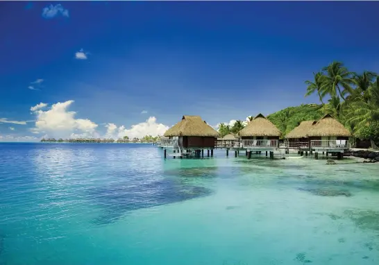  ??  ?? Island idyll: Beach huts in French Polynesia, above; Auckland, New Zealand, left, starting point for the ‘South Pacific Splendors’ cruise