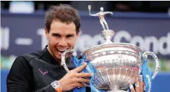  ??  ?? BARCELONA: Spanish tennis player Rafael Nadal celebrates with his trophy after winning Austrian tennis player Dominic Thiem at the end of the ATP Barcelona Open “Conde de Godo” tennis tournament final. —AFP BARCELONA: