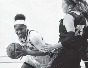  ?? STAFF PHOTO BY ROBIN RUDD ?? UTC’s Aryanna Gilbert looks for an opening while being guarded by Wofford’s Jamie Grob during the Mocs’ 76-56 home win on Saturday.