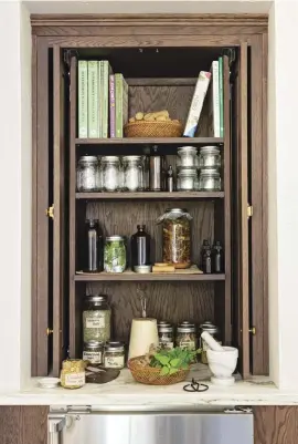  ?? ?? |LEFT| HEALTHY HUTCH. A closer look at the apothecary hutch with pocket doors. It houses Celesta’s herbs and tinctures