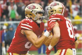  ?? Thearon W. Henderson / Getty Images ?? Rookie tight end George Kittle (left) and rookie wide receiver Trent Taylor celebrate after Taylor caught a touchdown pass against the Jaguars. Kittle had the 49ers’ other touchdown reception in the 44-33 win at home.