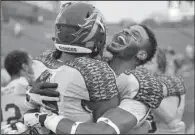  ?? AP/DAVID RICHARD ?? Western Michigan wide receiver Carrington Thompson (right) hugs teammate Corey Davis following Friday’s 35-30 victory over No. 24 Toledo in Toledo, Ohio.