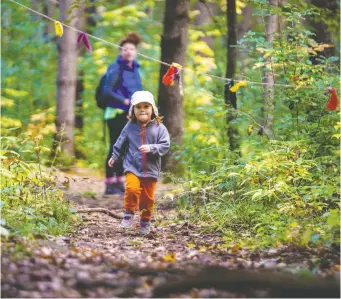  ?? ERROL McGIHON ?? Three-yeear-old Quincy Newlands runs in the woods Friday at a pop-up adventure playground.