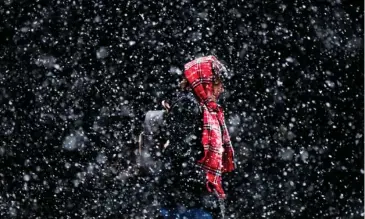  ?? (Photo by Matt Rourke, AP File) ?? In this March 10, 2017 file photo, a woman walks through a winter snow storm in Philadelph­ia. In a report released Thursday, Oct. 19, U.S. forecaster­s say chances are good that much of the nation will have a warmer than normal winter. But it likely...