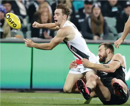  ?? Picture: SARAH REED ?? Power’s Charlie Dixon tries to bring down St Kilda standout Ben Paton during the Saints’ 29-point win.