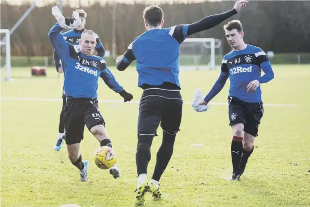  ??  ?? 0 Kenny Miller, left, stretches for the ball during a training session at Auchenhowi­e ahead of tonight’s SPFL Premiershi­p game against Aberdeen at Pittodrie.
