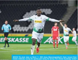  ??  ?? BERLIN: File photo taken on March 11, 2020 shows Moenchengl­adbach’s Swiss forward Breel Embolo celebrates scoring the opening goal during the German first division Bundesliga football match. The Bundesliga resumes with strict sanitary rules for players and spectators that could inspire other countries amid the pandemic of the novel coronaviru­s (COVID-19). —AFP