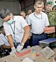  ??  ?? Custom officials show how the Cocaine was packed in the sugar consignmen­t