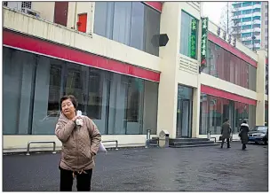 ?? AP/DITA ALANGKARA ?? A pedestrian passes one of the “Singapore shop” outlets in Pyongyang, North Korea, that sell products that are banned under sanctions imposed by the United Nations and the United States.