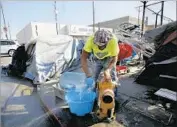  ??  ?? KEVIN STEWART opens a fire hydrant near skid row to get water for drinking and bathing.