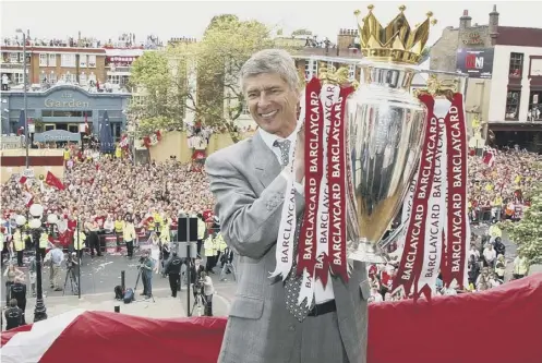  ??  ?? Arsene Wenger with the Premier League trophy won by his career-defining Invincible­s in season 2003-2004.