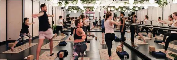  ?? Emily Andrews/The New York Times ?? The New York yoga studio at Rise, a wellness center opened by WeWork, the shared work space company. WeWork said it has sold 150,000 membership­s to Rise that entitle users to work out of its various locations.