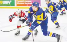  ??  ?? Blades defenceman Radek Kucerik under pressure from Lethbridge Hurricanes forward Noah Boyko in WHL action in Saskatoon Oct. 12.