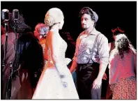  ?? Though they never met in real life, Eva Peron (Yael Reich) and Che Guevara (Lance Galgon) interact via music by Andrew Lloyd Webber and lyrics by Tim Rice in Evita. ??