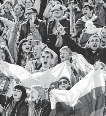  ?? JACK GRUBER, USA TODAY SPORTS ?? Russian fans cheer at the start of Sunday’s men’s cross- country 50km race. Their faith paid off with a podium sweep by Alexander Legkov, Maxim Vylegzhani­n and Ilia Chernousov.