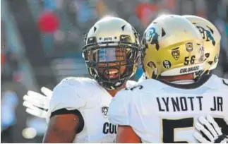  ?? Timothy Gonzalez, The Associated Press ?? Colorado wide receiver Bryce Bobo, left, celebrates with teammate Tim Lynott Jr. after Bobo’s touchdown in the second half of Saturday’s game at Oregon State. Bobo caught nine passes for 126 yards and two touchdowns.