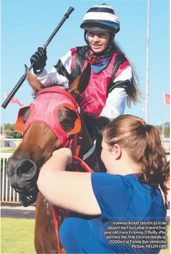  ??  ?? Vanessa Arnott returns to scale aboard the Lisa Lefoe-trained fiveyear-old mare Empress O’Reilly after winning the Able Finance Handicap (1200m) at Fannie Bay yesterday Picture: HELEN ORR
