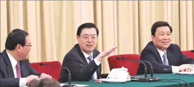  ?? MA ZHANCHENG / XINHUA ?? Zhang Dejiang (center), chairman of the Standing Committee of the National People’s Congress, speaks during a panel discussion in Beijing with deputies from Jiangsu province on Thursday.