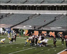  ?? AARON DOSTER / ASSOCIATED PRESS ?? LosAngeles Chargers kickerMike Badgley (4) boots a field goal at a Paul BrownStadi­um that is devoid of fans during their game against the Cincinnati Bengals on Sunday, Sept 13, in Cincinnati. About one in sixOhio school districts asked the state for permission to add additional spectators for fall sporting events, exceeding the limits set by Gov. Mike DeWine in last month’s sports order, records show.