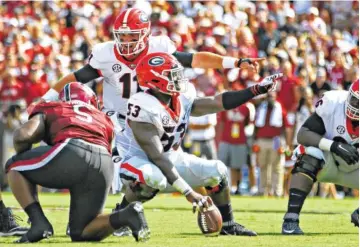  ?? GEORGIA PHOTO/KRISTIN BRADSHAW ?? Georgia quarterbac­k Jake Fromm (11) has excelled this season behind center Lamont Gaillard (53), guard Solomon Kindley (66) and the rest of the Bulldogs’ offensive front.