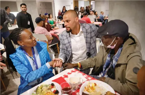  ?? (Tom Fox/the Dallas Morning NEWS/TNS) ?? Dallas Cowboys quarterbac­k Dak Prescott shakes hands with intestinal cancer patient Jewell Sparks of Germany Monday as he toured the American Cancer Society Jerry and Gene Jones Family Hope Lodge in Dallas. She was joined at dinner by colon cancer patient Tolu Agunbiade, 71, right. March is Colon Cancer Awareness Month, and Dak is not only a Global Ambassador for the American Cancer Society, but he lost his mother to colon cancer.