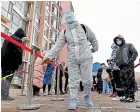  ?? AP ?? A worker sprays disinfecta­nt as residents line up for a coronaviru­s test Tianjin.