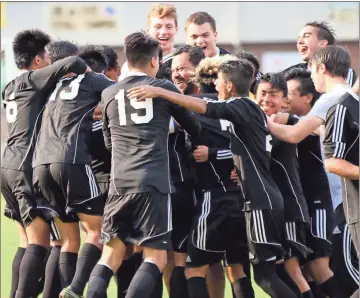  ?? Jeremy Stewart / Rome News-Tribune ?? The Coosa boys’ soccer team celebrates with coach Ruben Maldonado (center) after defeating Pepperell and winning the Region 7-AA title Thursday at Pepperell. The Eagles defeated the Dragons 3-1.