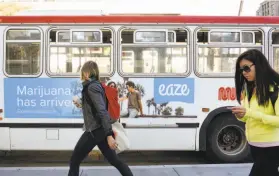  ?? Michael Short / Special to The Chronicle 2017 ?? Green Coast, which sells pot via Eaze software, advertised on this bus, has laid off 136 workers but has not indicated whether the company was shutting down.