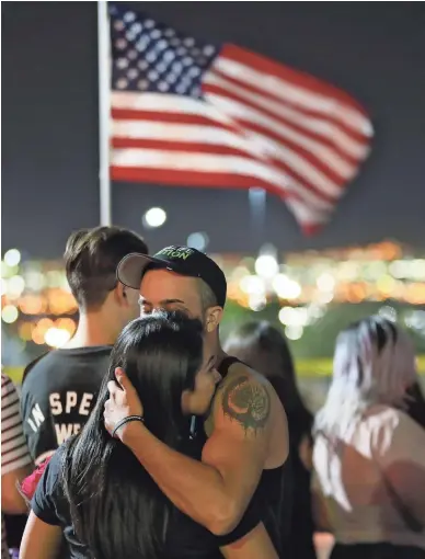  ??  ?? People on Monday visit a memorial outside a Walmart in El Paso, Texas, where a mass shooting killed 22 people and injured 25 others on Saturday.