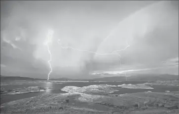  ?? AL SCHABEN/TRIBUNE NEWSPAPERS ?? Lightning rages over Nevada’s Lake Mead National Recreation Area last week even as drought grips the Southwest. The lake itself is at a historic low, but the park is the nation’s sixth most popular destinatio­n of its 407 national parks.