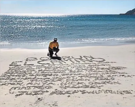  ?? FACEBOOK ?? In the sand on a beach at the end of his Box Run El Camino, Mike Strange wrote the names of all the children he ran for.