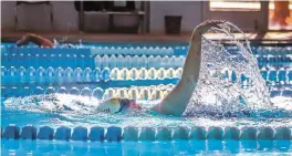  ?? GABRIELA CAMPOS/THE NEW MEXICAN ?? Ann Mackinnon swims the backstroke Wednesday as part of her weekday 1,500yard routine at Salvador Perez Pool. The pool’s hours for lap swimming have been shortened amid a lifeguard shortage.