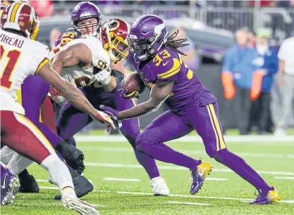  ??  ?? The Vikings’ Dalvin Cook, right, scores a touchdown against the Redskins.