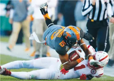  ?? STAFF FILE PHOTO BY DOUG STRICKLAND ?? Tennessee wide receiver Jauan Jennings leaps over Nebraska’s Lamar Jackson during the Vols’ 38-24 Music City Bowl win this past December. Jennings had a breakout season last year but will be counted on to provide more leadership in 2017.